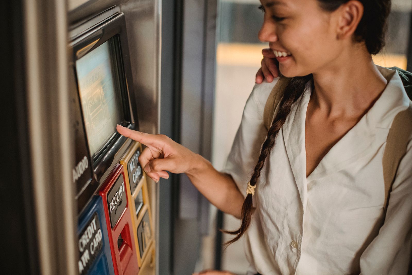 Kvinna väljer en vara i en varuautomat med pekskärm